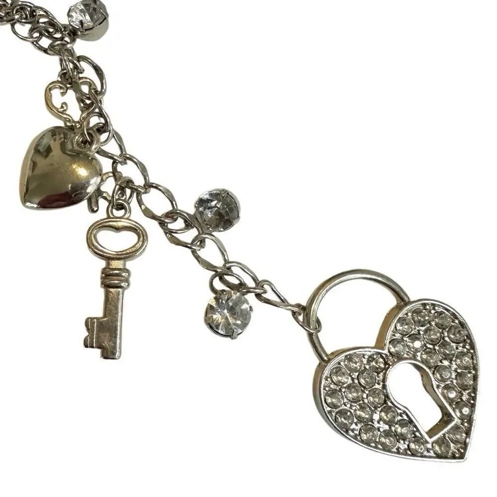 Silver tone heart and key long charm necklace